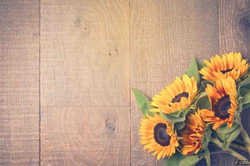 Autumn background with sunflowers on wooden table. View from abo