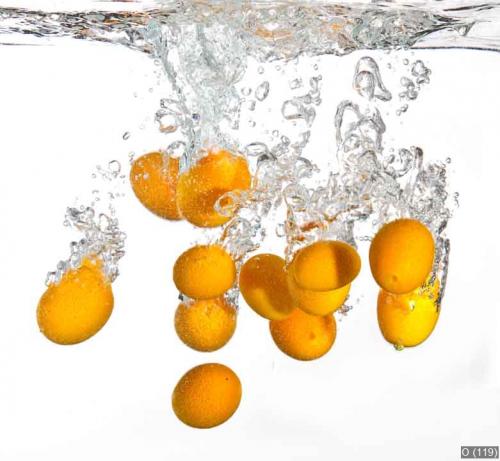 Small oranges falling into water