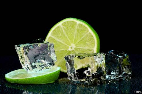 Ice cubes with lime on darck background