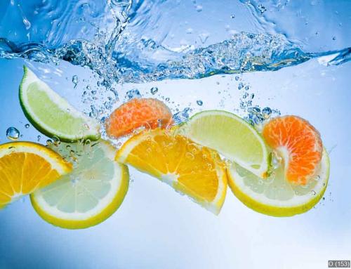 Tropical fruits fall deeply under water with a big splash