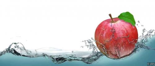 Red, juicy apple as a card on the water background.