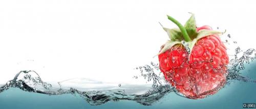 Raspberries in a spray of water.