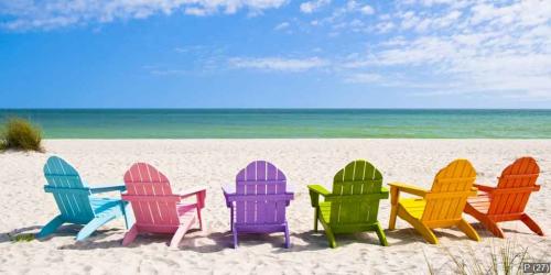 Adirondack Beach Chairs on a Sun Beach in front of a Holiday Vac